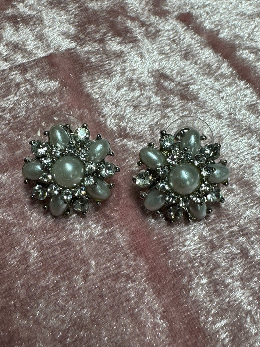 Vintage-style rhinestone earrings featuring a starburst or floral design
