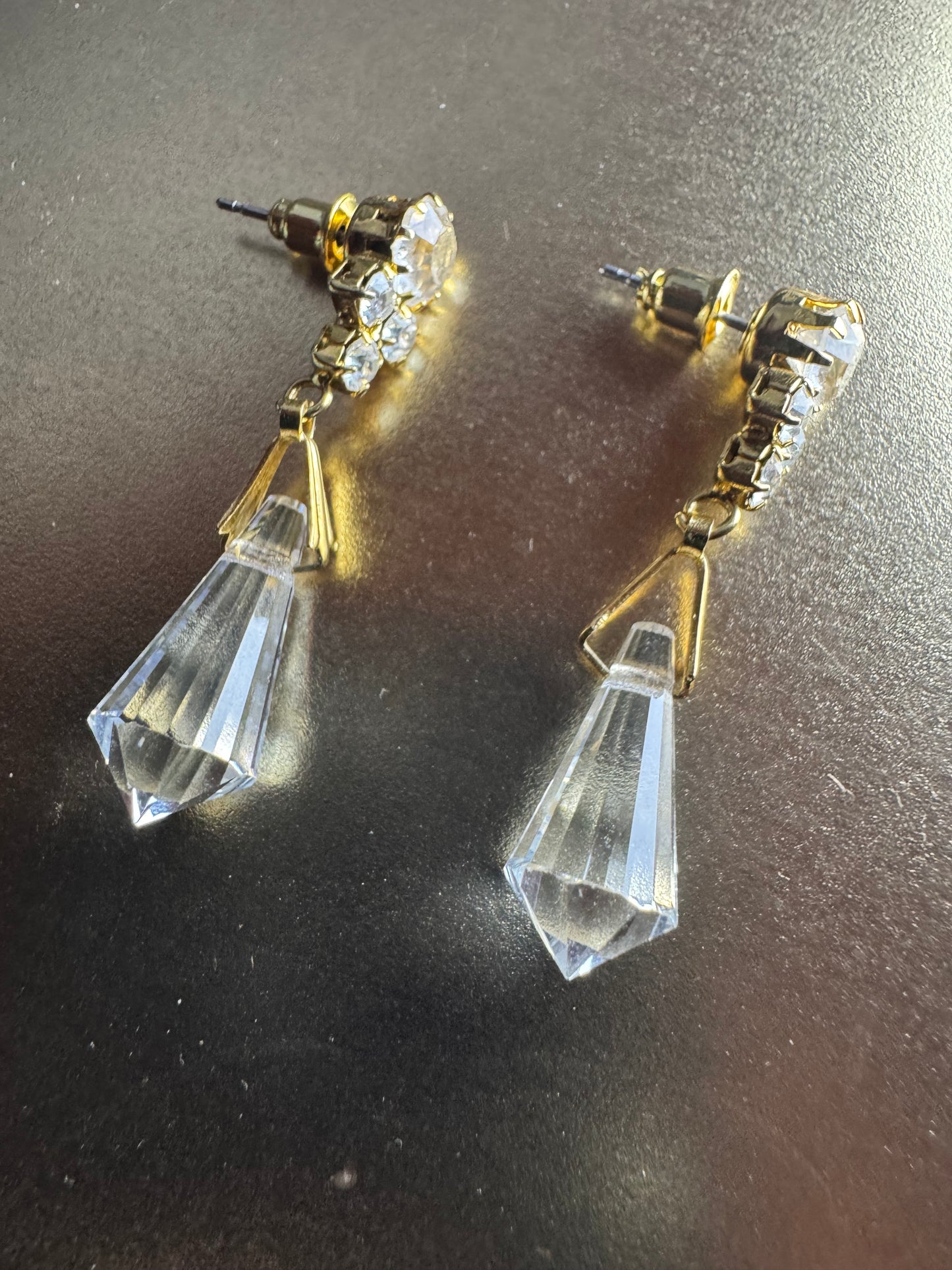 Vintage inspired gold tone linear drop earrings featuring faceted clear glass crystal icicle drops