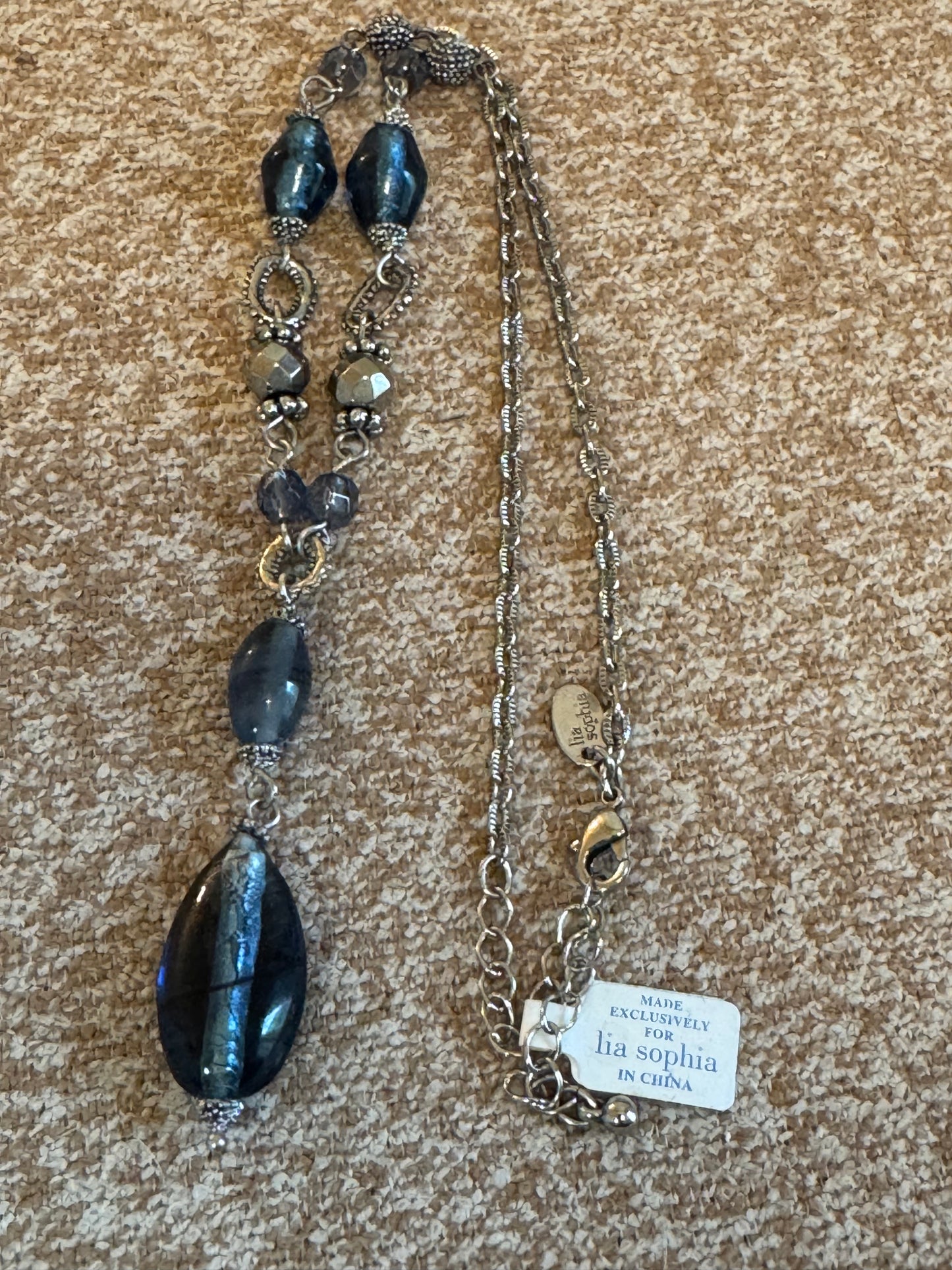 Lia Sophia "Buena Vista" necklace featuring shimmering blue glass beads and silvery accents in a Y-drop design.