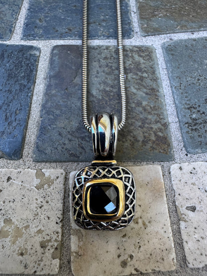 Pendant Necklace Featuring a Black Gemstone Set in a Textured Silver and Gold-accented Frame