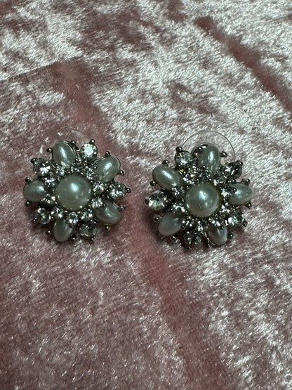 Vintage-style rhinestone earrings featuring a starburst or floral design