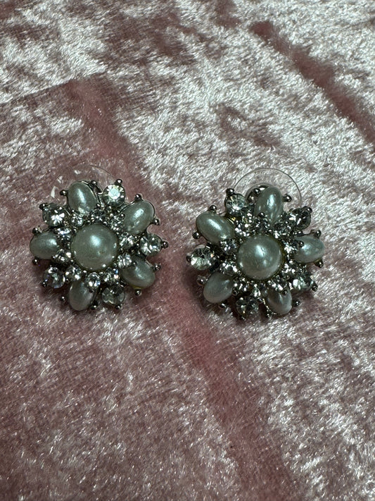 Vintage-style rhinestone earrings featuring a starburst or floral design