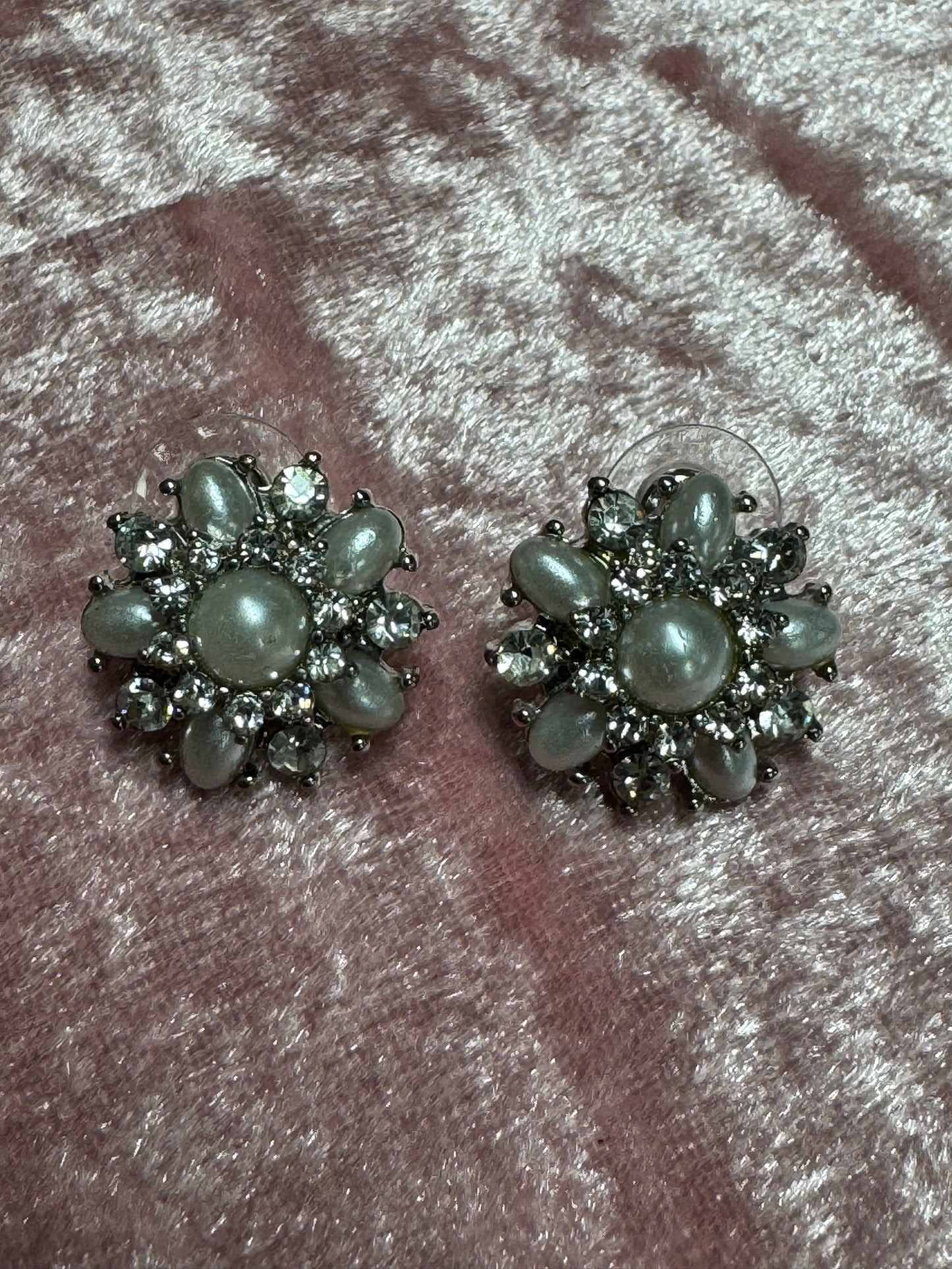 Vintage-style rhinestone earrings featuring a starburst or floral design