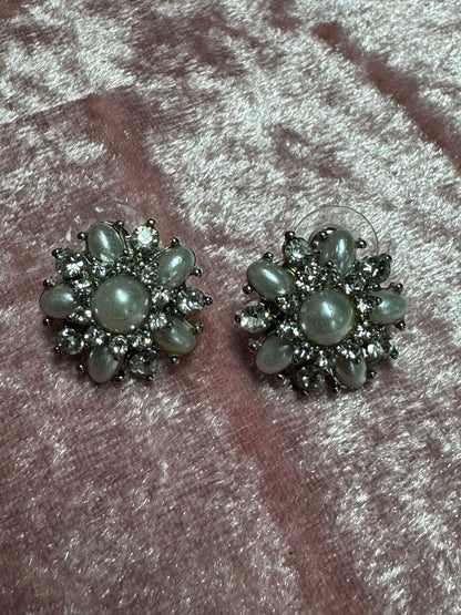 Vintage-style rhinestone earrings featuring a starburst or floral design