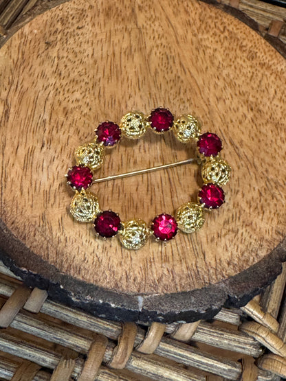 Vintage gold-tone brooch with red rhinestones