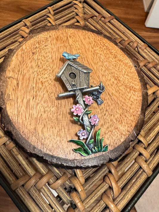 Vintage Signed Jonette Jewelry (JJ) brooch featuring a silver-tone birdhouse, a bluebird, and pink enamel flowers