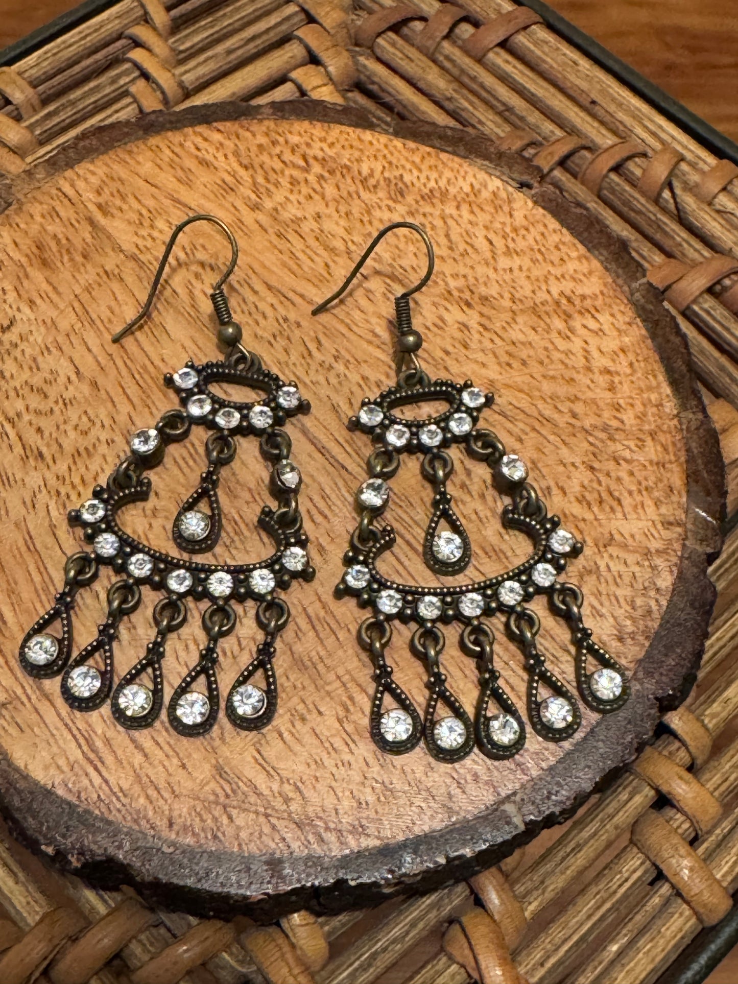Bohemian-style brass earrings featuring a dangle chandelier design with clear crystal accents