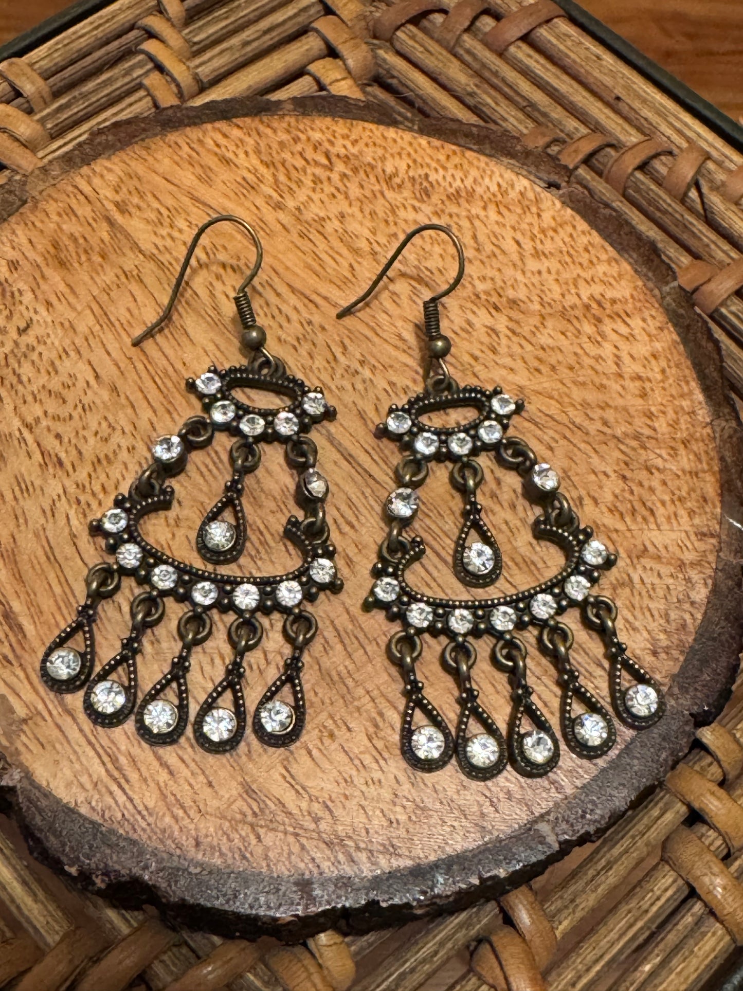 Bohemian-style brass earrings featuring a dangle chandelier design with clear crystal accents