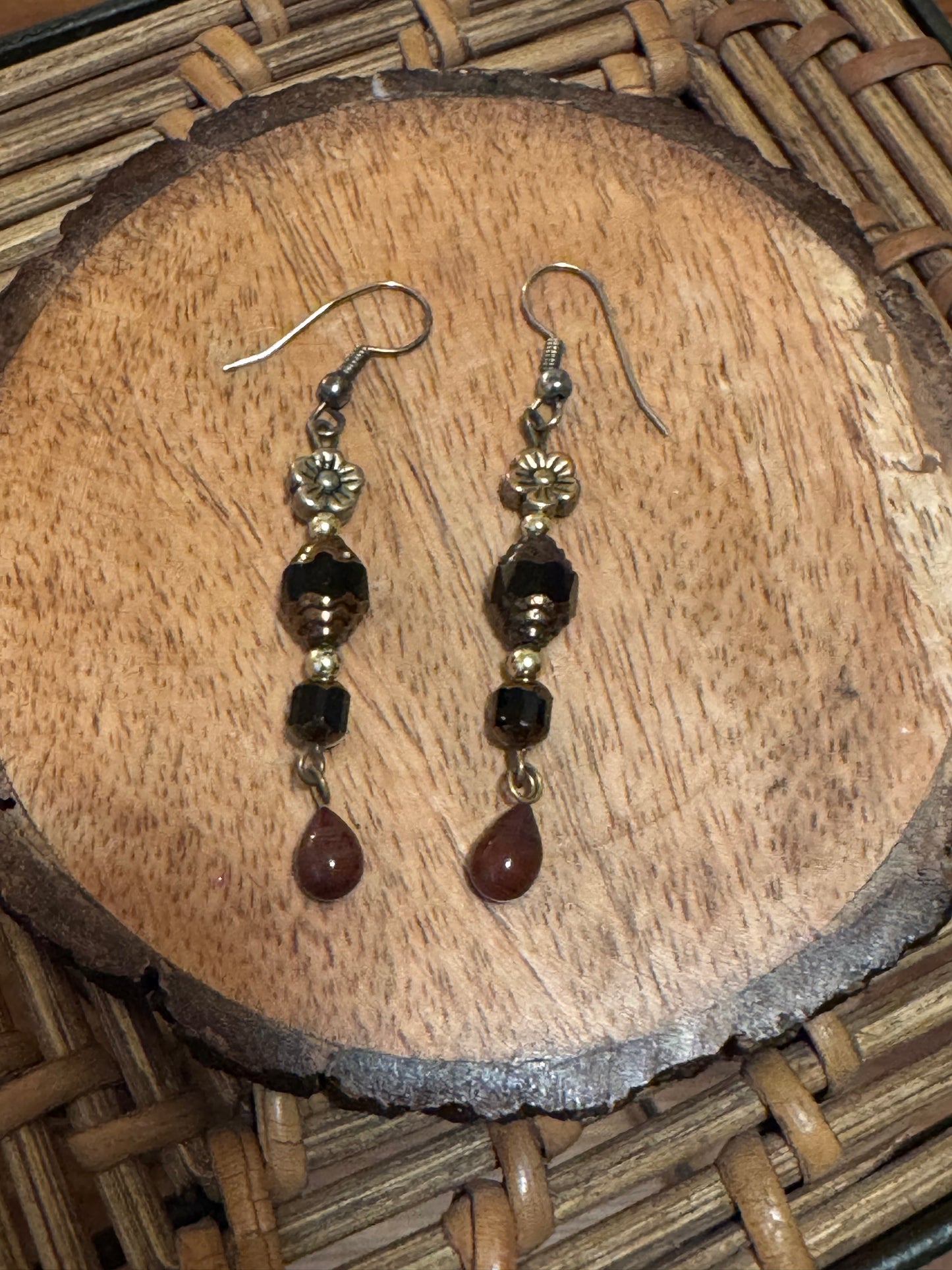 Artisanal dangle earrings featuring brown and black faceted beads