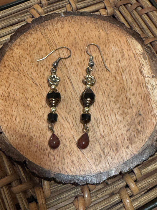Artisanal dangle earrings featuring brown and black faceted beads