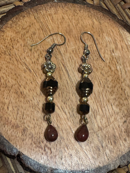 Artisanal dangle earrings featuring brown and black faceted beads