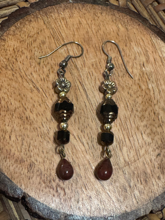 Artisanal dangle earrings featuring brown and black faceted beads