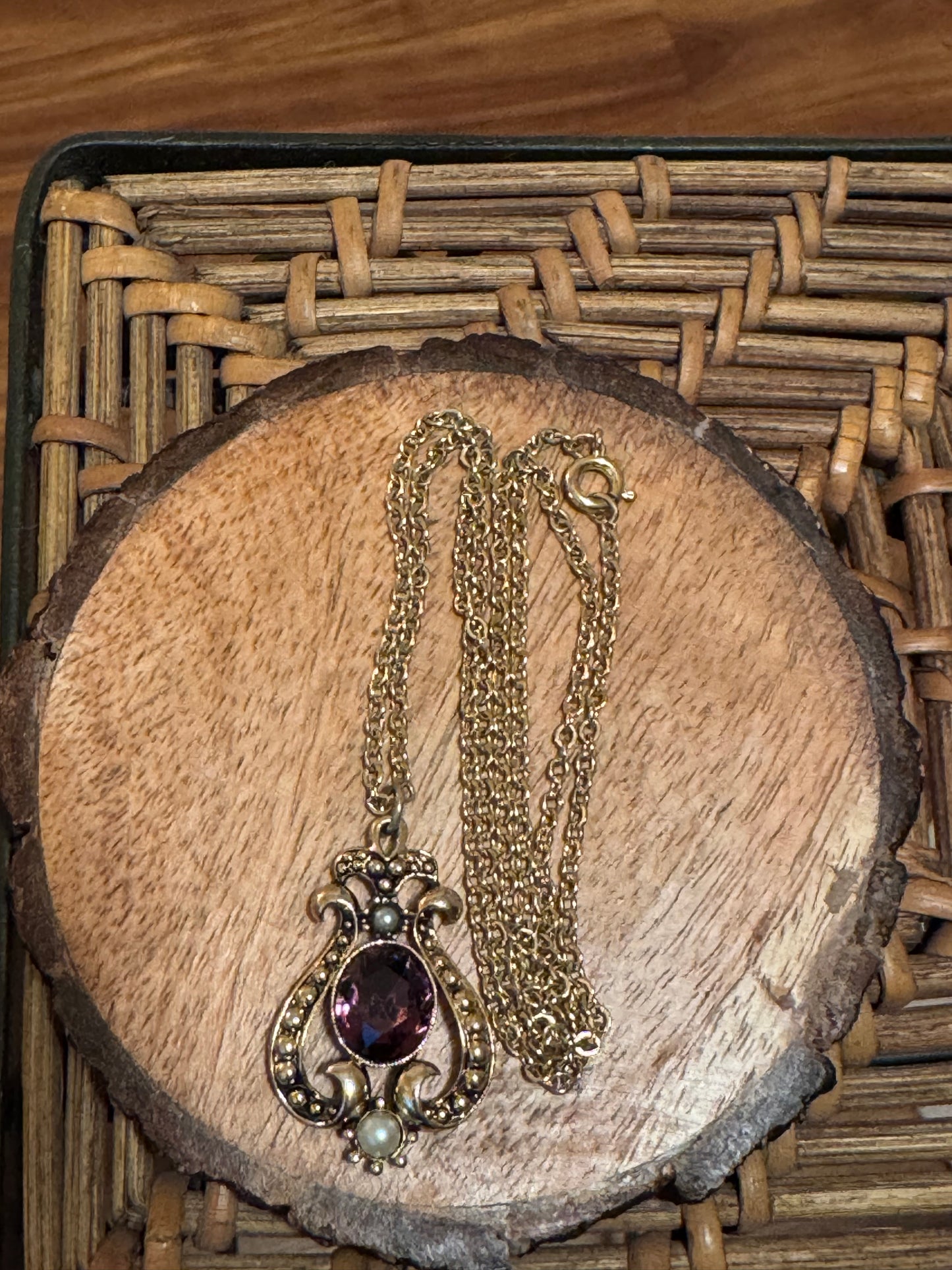Vintage 1974 Avon "Queensbury" necklace featuring a purple faux amethyst stone and faux pearls set in a gold-tone pendant