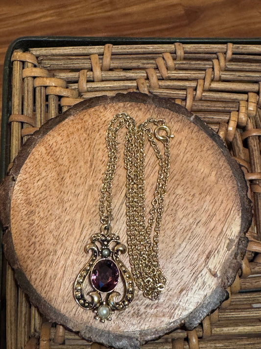 Vintage 1974 Avon "Queensbury" necklace featuring a purple faux amethyst stone and faux pearls set in a gold-tone pendant