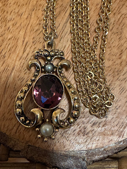 Vintage 1974 Avon "Queensbury" necklace featuring a purple faux amethyst stone and faux pearls set in a gold-tone pendant