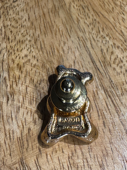 Vintage gold-tone Avon Bear lapel pin featuring a purple rhinestone heart