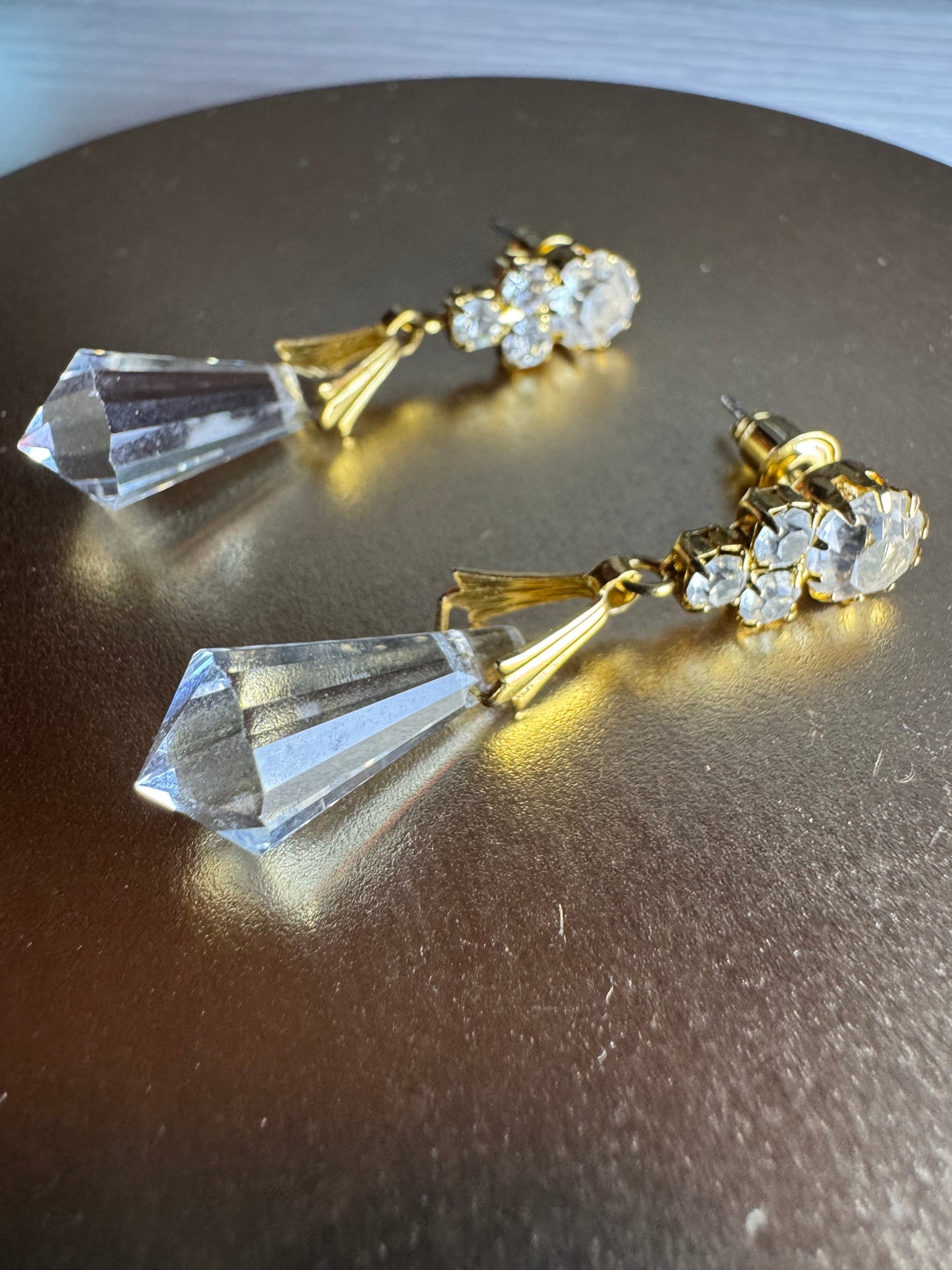 Vintage inspired gold tone linear drop earrings featuring faceted clear glass crystal icicle drops