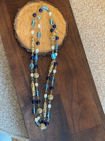 Lia Sophia necklace features a long, beaded design with a blue, gold-tone, and faux pearl color scheme