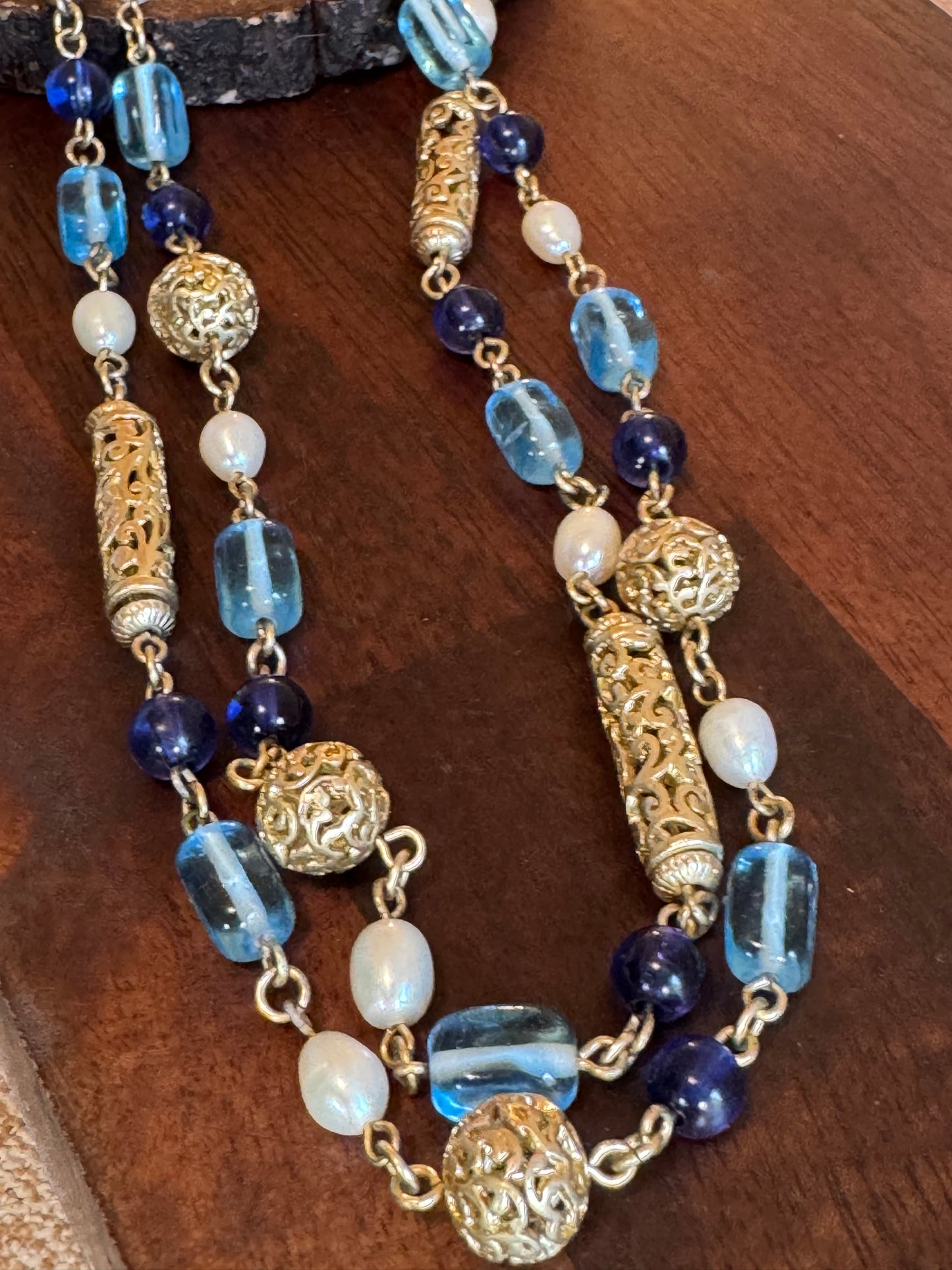 Lia Sophia necklace features a long, beaded design with a blue, gold-tone, and faux pearl color scheme