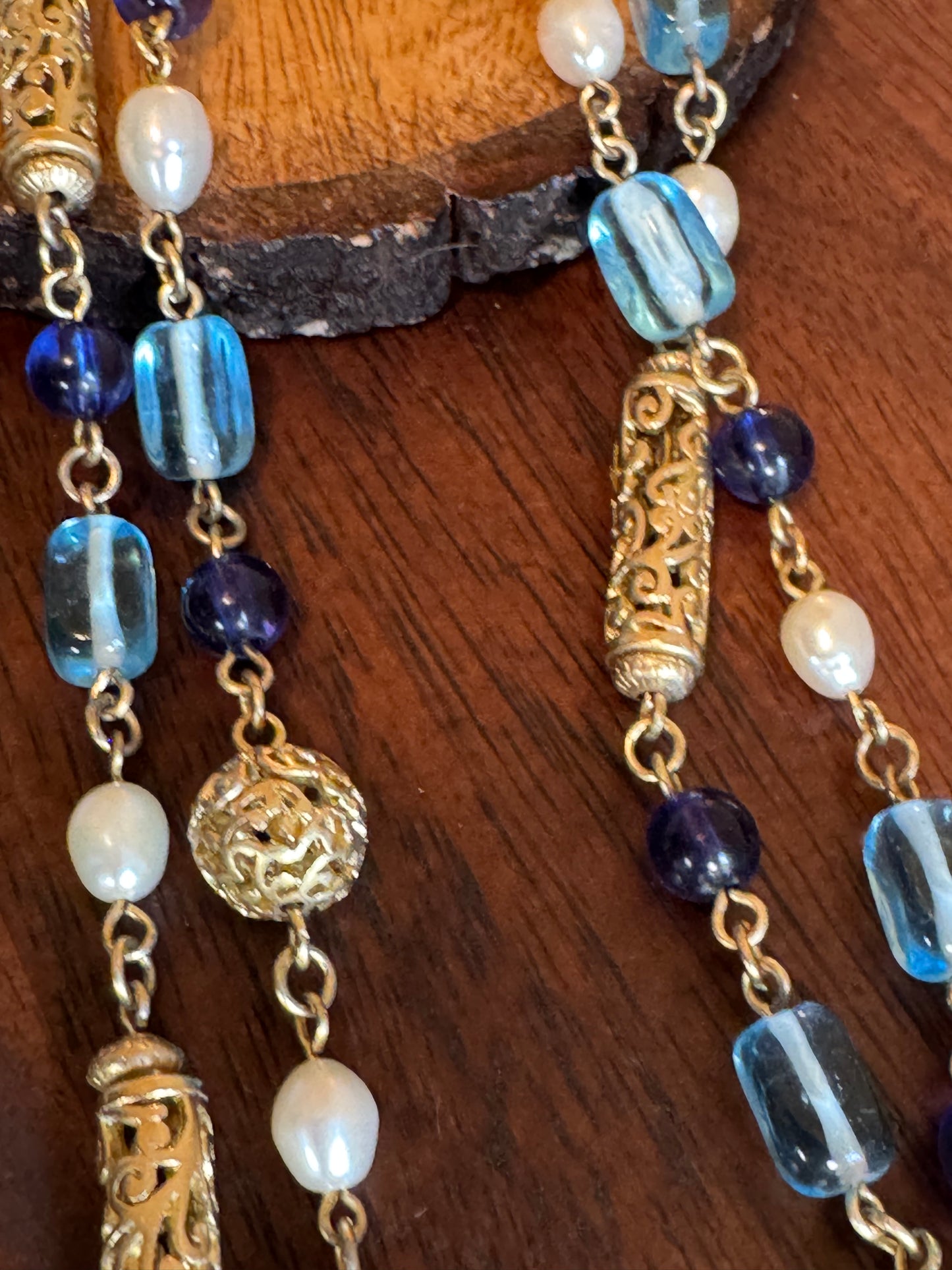 Lia Sophia necklace features a long, beaded design with a blue, gold-tone, and faux pearl color scheme
