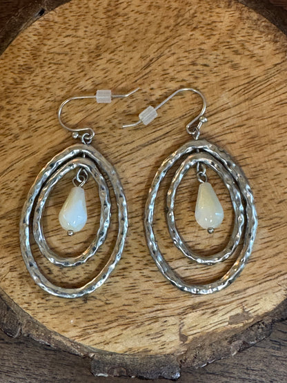 Lia Sophia earrings feature a silver-tone hammered oval design with a mother of pearl pearlescent drop