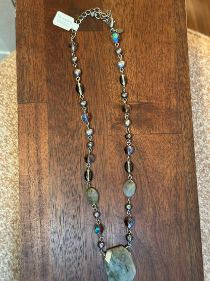 Lia Sophia necklace featuring a mix of iridescent, pearl, and faceted gray beads arranged on a silver-toned chain