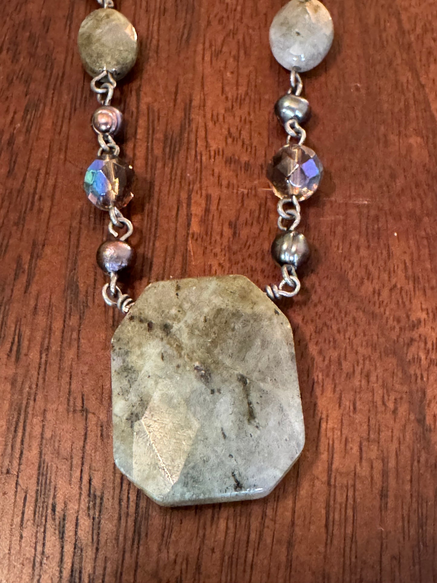 Lia Sophia necklace featuring a mix of iridescent, pearl, and faceted gray beads arranged on a silver-toned chain