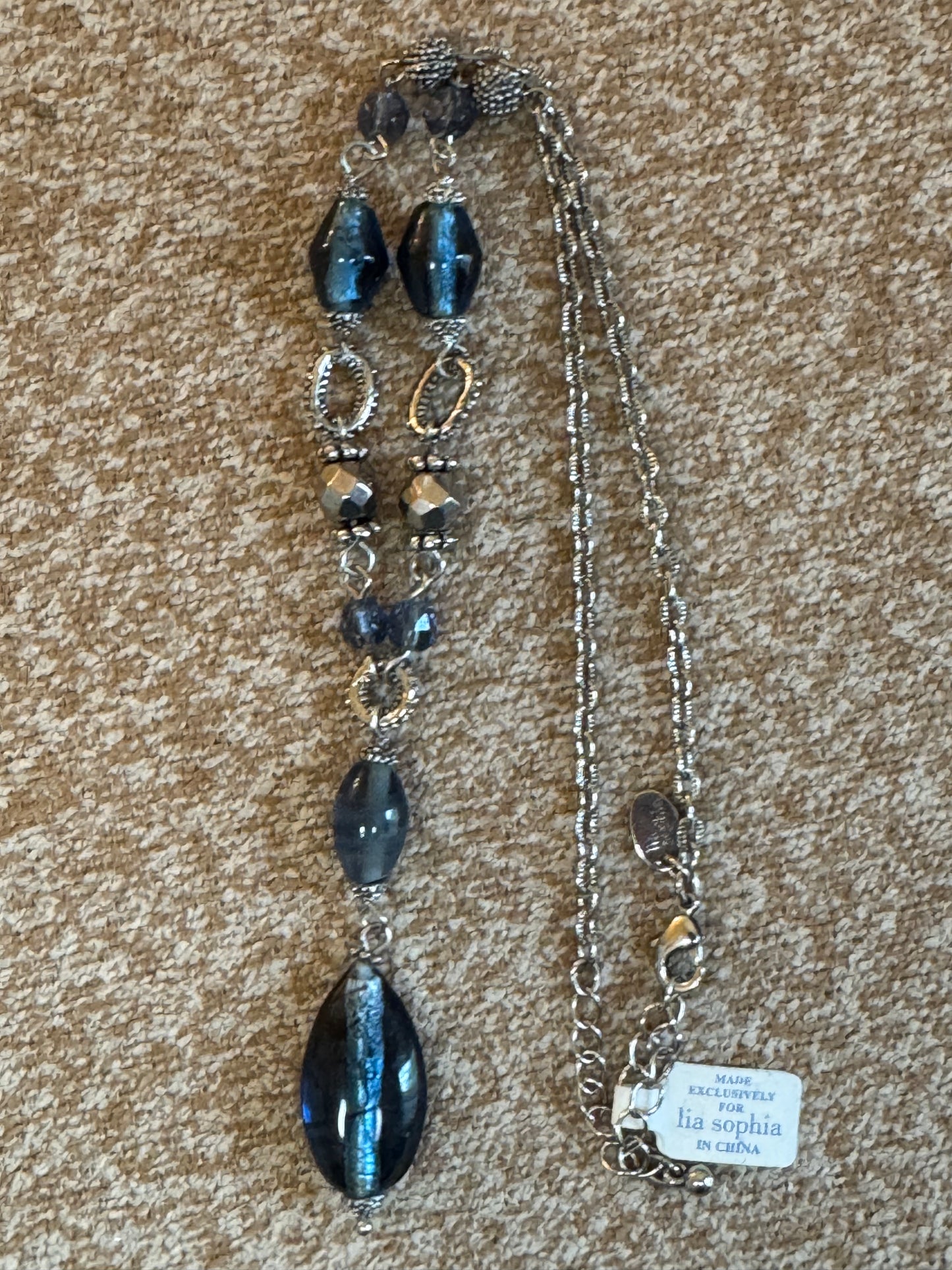 Lia Sophia "Buena Vista" necklace featuring shimmering blue glass beads and silvery accents in a Y-drop design.