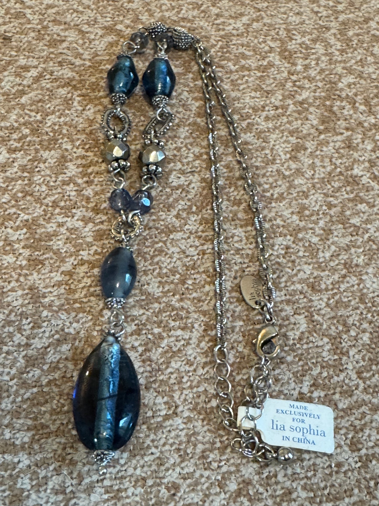 Lia Sophia "Buena Vista" necklace featuring shimmering blue glass beads and silvery accents in a Y-drop design.