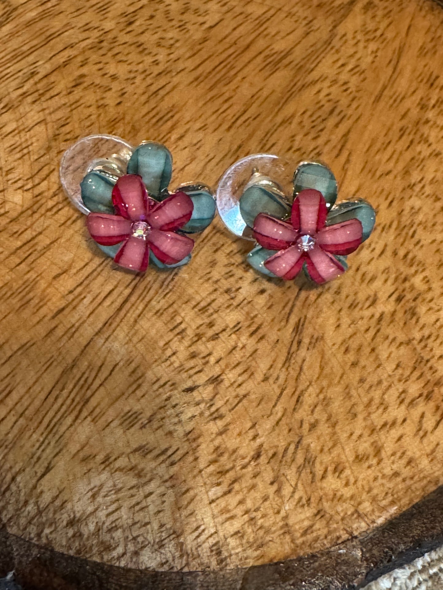 Robert Rose earrings feature a layered flower design