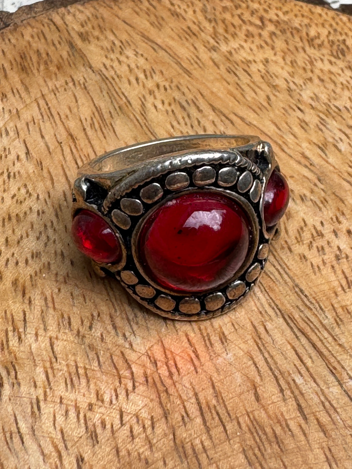 Vintage-style chunky silver statement ring featuring a prominent red cabochon stone
